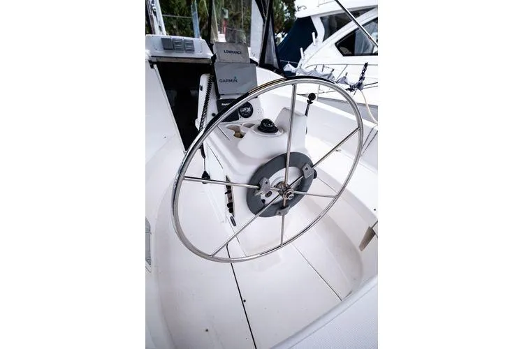 Slide: The Image of Steering wheel of a 2001 Hunter 340 sailboat, featuring navigation equipment. - 11