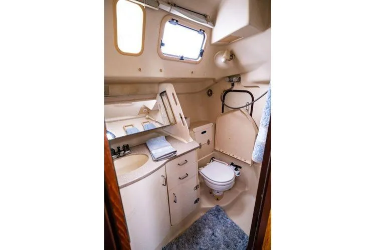 Slide: The Image of Compact bathroom interior of 2001 Hunter 340 sailboat with sink, toilet, and storage. - 16