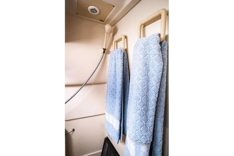 Slide: The Image of Shower area in 2001 Hunter 340 yacht with blue towels and handheld showerhead. - 17