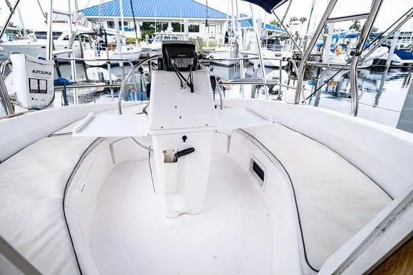Slide: The Image of 2001 Hunter 340 sailboat cockpit with white seating and marina view. - 23