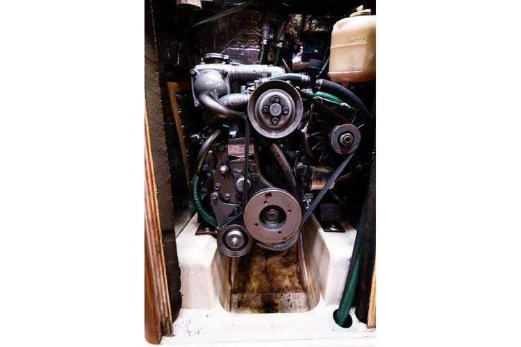 Slide: The Image of Engine compartment of a 2001 Hunter 340 sailboat, showcasing mechanical components and belts. - 24