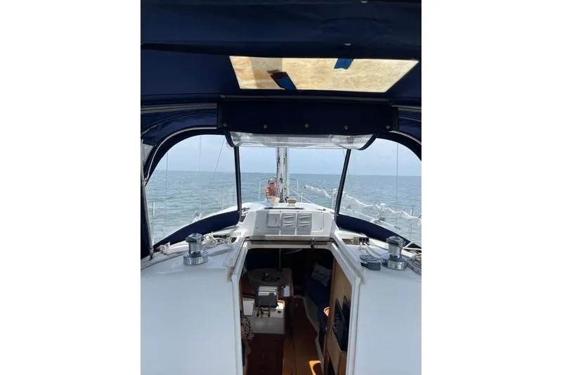 Slide: The Image of Interior view of a 2001 Hunter 340 sailboat cockpit with ocean in background. - 38