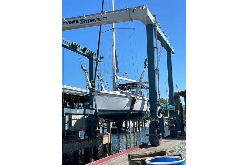 Slide: The Image of 2001 Hunter 340 sailboat lifted by Marine Travelift at a marina. - 41