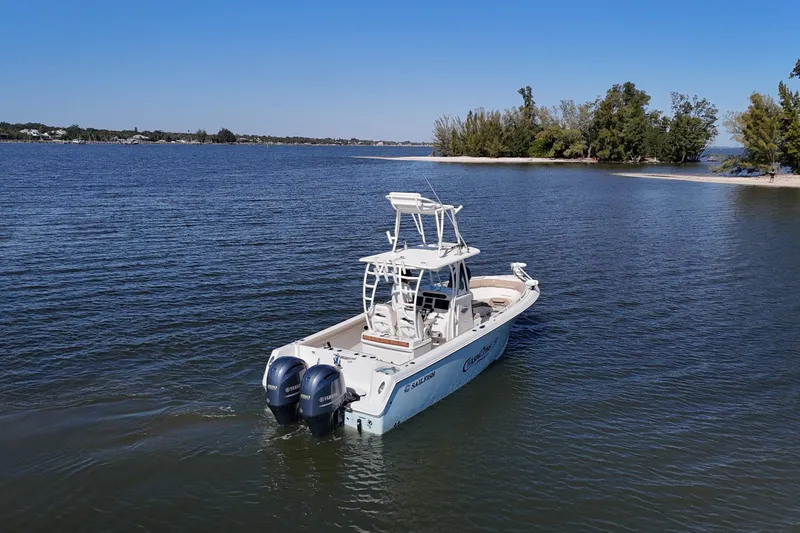 Slide: The Image of 2018 Sailfish 270 CC boat on calm water near a small island. - 11