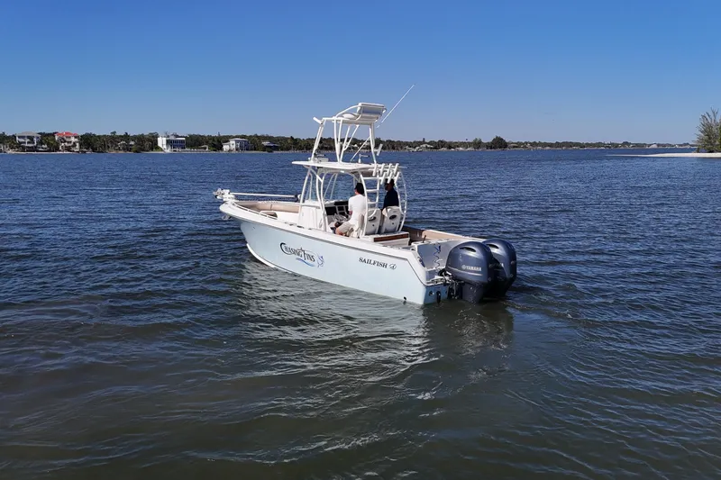 Slide: The Image of 2018 Sailfish 270 CC boat on calm water with twin Yamaha engines. - 14