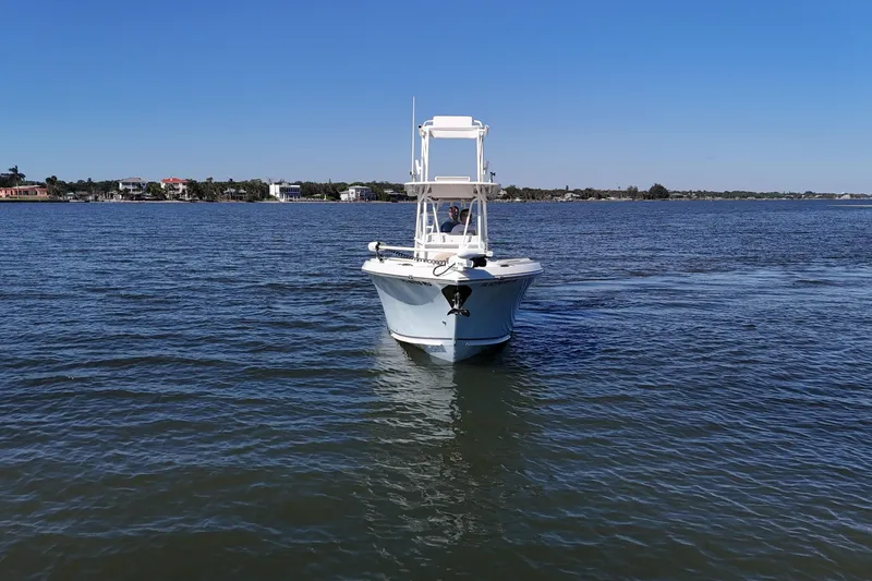 Slide: The Image of 2018 Sailfish 270 CC boat on calm water under clear blue sky. - 17