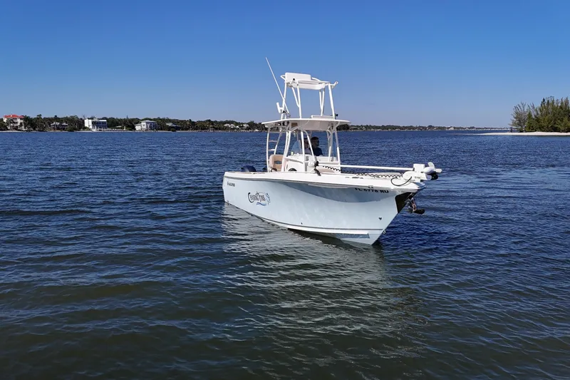 Slide: The Image of 2018 Sailfish 270 CC boat on calm water under clear blue sky. - 18