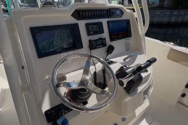 Slide: The Image of 2018 Sailfish 270 CC boat dashboard with navigation and control systems. - 20