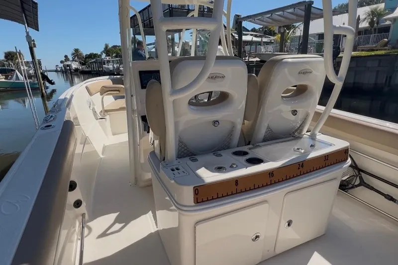 Slide: The Image of 2018 Sailfish 270 CC boat interior with dual seats and measuring board. - 21