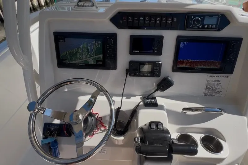 Slide: The Image of 2018 Sailfish 270 CC boat dashboard with navigation and control systems. - 22