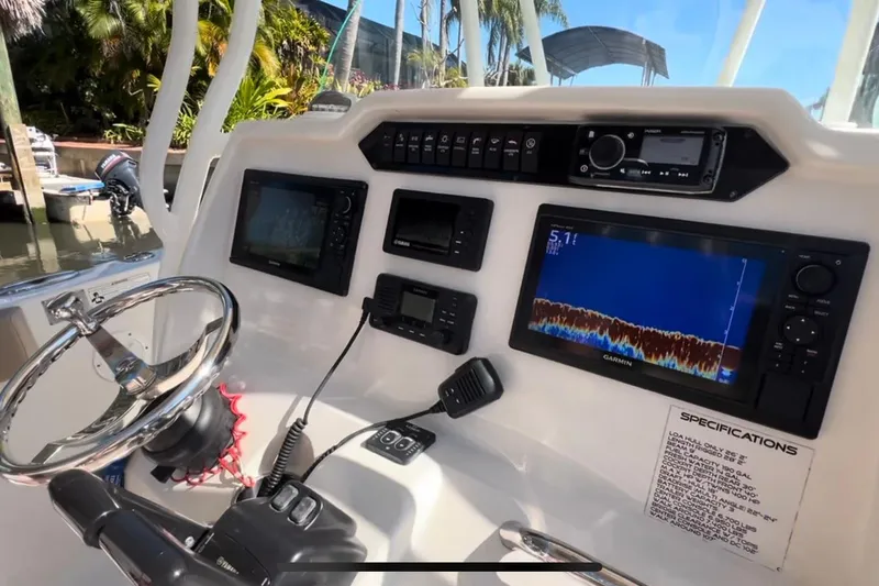 Slide: The Image of 2018 Sailfish 270 CC boat dashboard with navigation and control systems. - 29