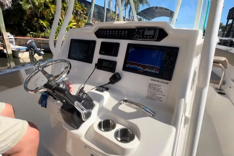 Slide: The Image of 2018 Sailfish 270 CC boat dashboard with steering wheel and navigation displays. - 30