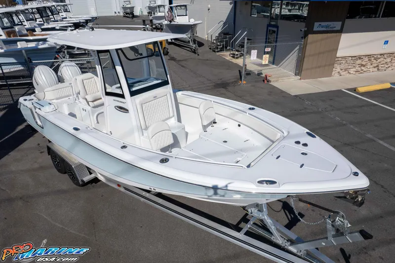 Slide: The Image of 2026 Sea Hunt Ultra 265 SE boat on trailer in marina parking lot. - 11