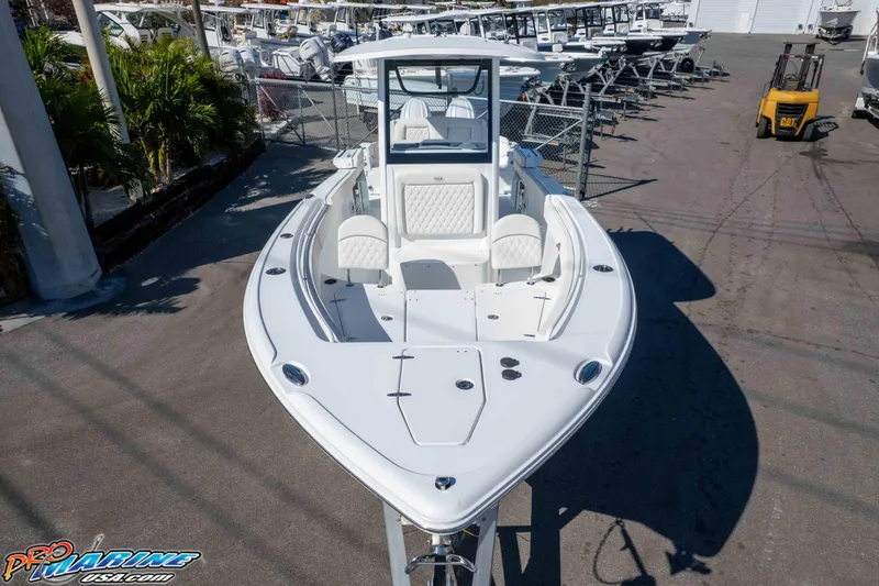 Slide: The Image of 2026 Sea Hunt Ultra 265 SE boat displayed at a marina, surrounded by other vessels. - 12