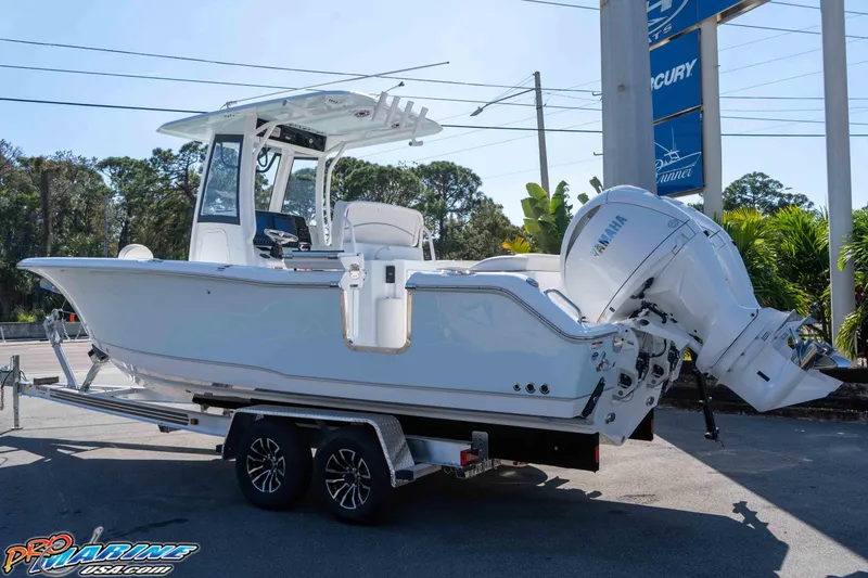 Slide: The Image of 2026 Sea Hunt Ultra 265 SE boat on trailer, featuring Yamaha outboard motor. - 15
