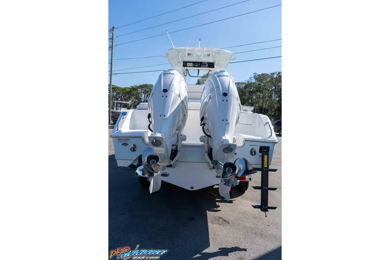 Slide: The Image of 2026 Sea Hunt Ultra 265 SE boat with dual outboard motors, rear view. - 16