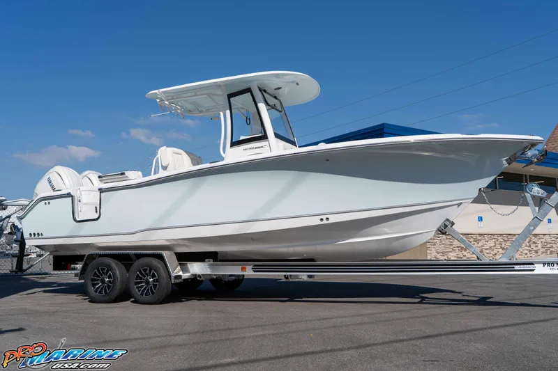 Slide: The Image of 2026 Sea Hunt Ultra 265 SE boat on trailer, displayed outdoors under clear blue sky. - 18