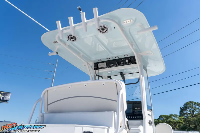 Slide: The Image of 2026 Sea Hunt Ultra 265 SE boat with T-top and electronics, under clear blue sky. - 20