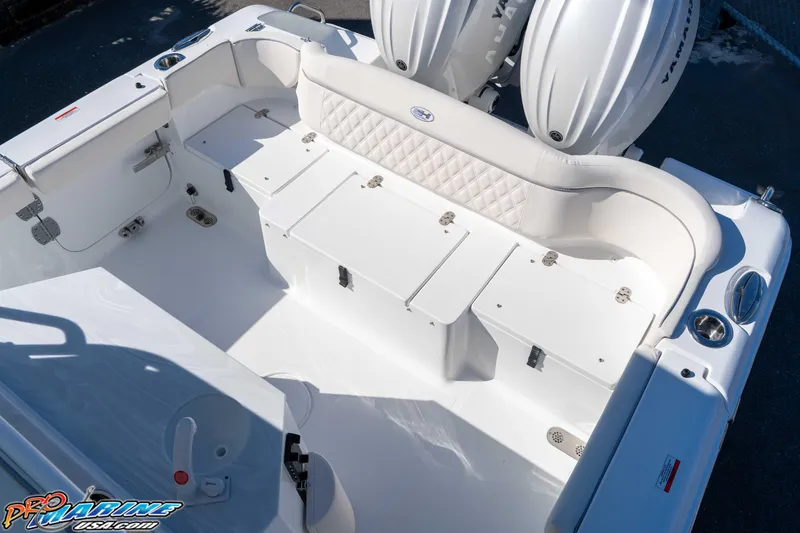 Slide: The Image of 2026 Sea Hunt Ultra 265 SE boat interior with white seating and storage compartments. - 22