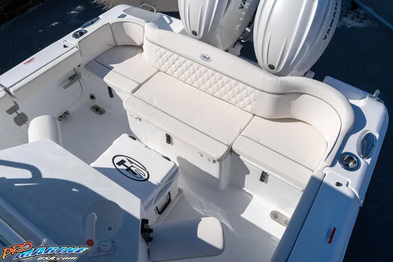 Slide: The Image of 2026 Sea Hunt Ultra 265 SE boat interior with white seating and dual engines. - 23