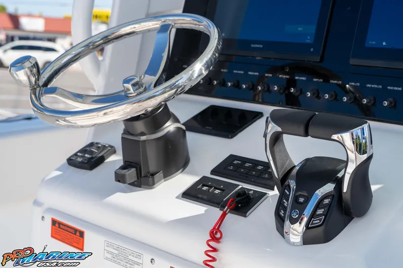 Slide: The Image of Control panel of 2026 Sea Hunt Ultra 265 SE boat with steering wheel and throttle. - 27