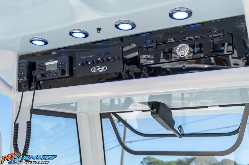 Slide: The Image of 2026 Sea Hunt Ultra 265 SE boat console with electronics and LED lights. - 28