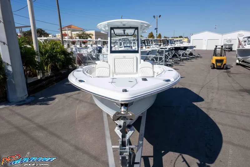 Slide: The Image of 2026 Sea Hunt Ultra 265 SE boat displayed at a dealership, front view. - 3
