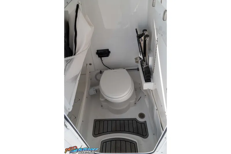 Slide: The Image of 2026 Sea Hunt Ultra 265 SE boat interior with compact marine toilet and storage. - 35