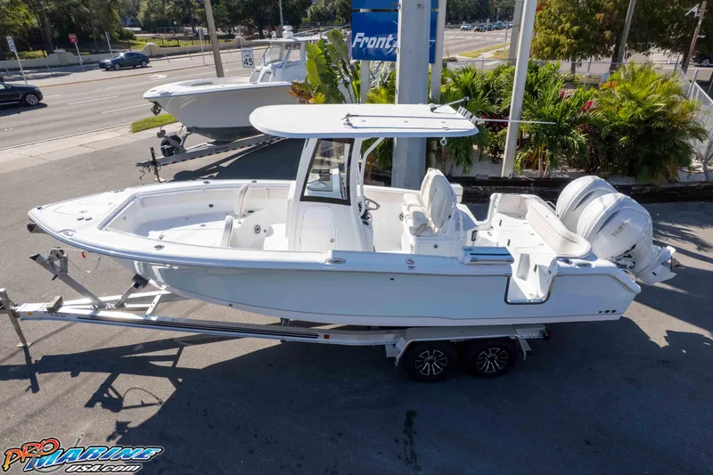 Slide: The Image of 2026 Sea Hunt Ultra 265 SE boat on trailer, parked outdoors, side view. - 6