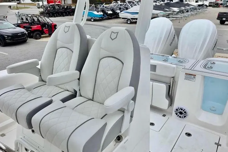 Slide: The Image of 2026 Sea Fox 288 Commander boat interior with luxurious seating and dual outboard engines. - 13