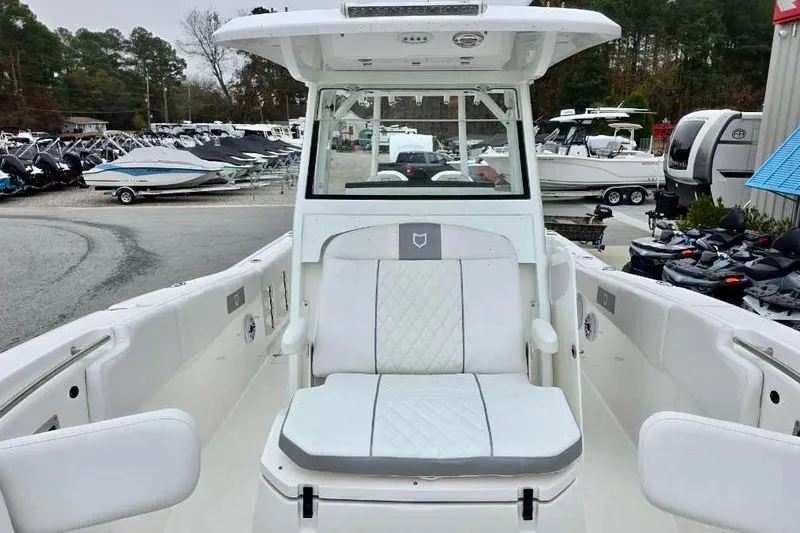Slide: The Image of 2026 Sea Fox 288 Commander boat interior with white seating and helm station. - 17