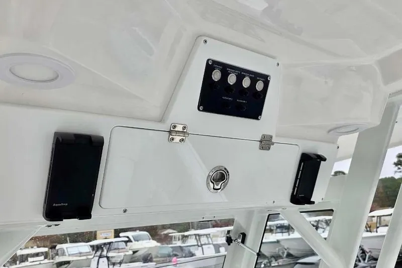 Slide: The Image of 2026 Sea Fox 288 Commander boat console with control panel and storage compartment. - 2