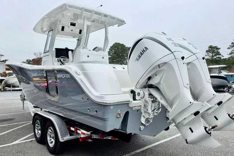 Slide: The Image of 2026 Sea Fox 288 Commander boat with dual Yamaha engines on a trailer. - 26