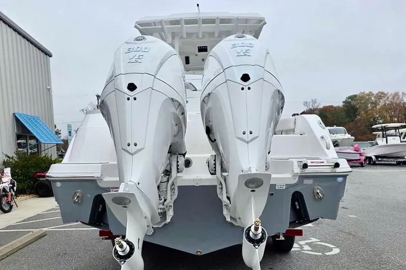 Slide: The Image of 2026 Sea Fox 288 Commander with dual outboard engines, rear view in a marina setting. - 27