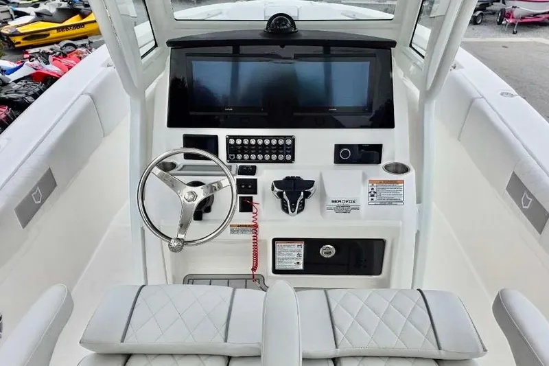 Slide: The Image of 2026 Sea Fox 288 Commander boat dashboard with steering wheel and control panel. - 4