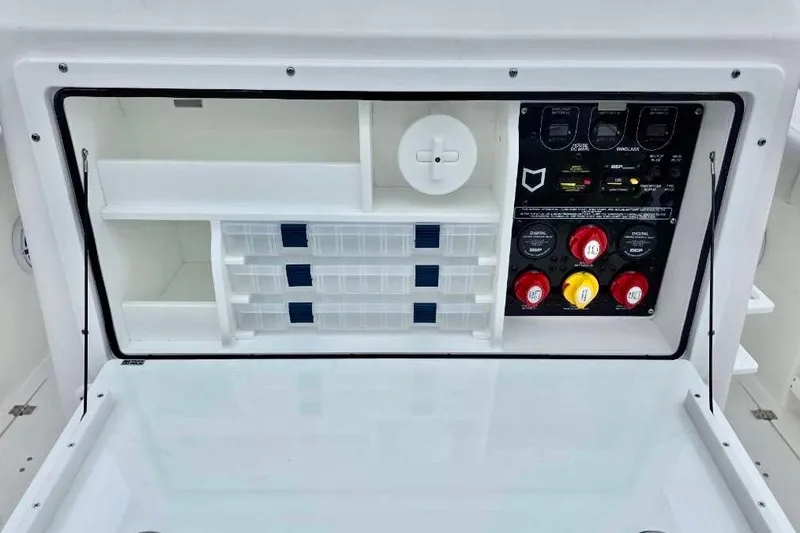 Slide: The Image of 2026 Sea Fox 288 Commander control panel with storage compartments and switches. - 7