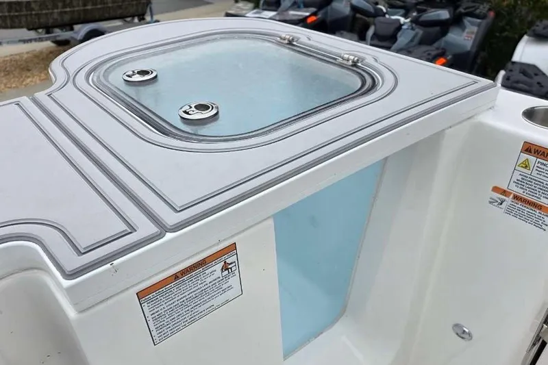 Slide: The Image of 2026 Sea Fox 288 Commander boat detail with storage compartment and warning labels. - 8