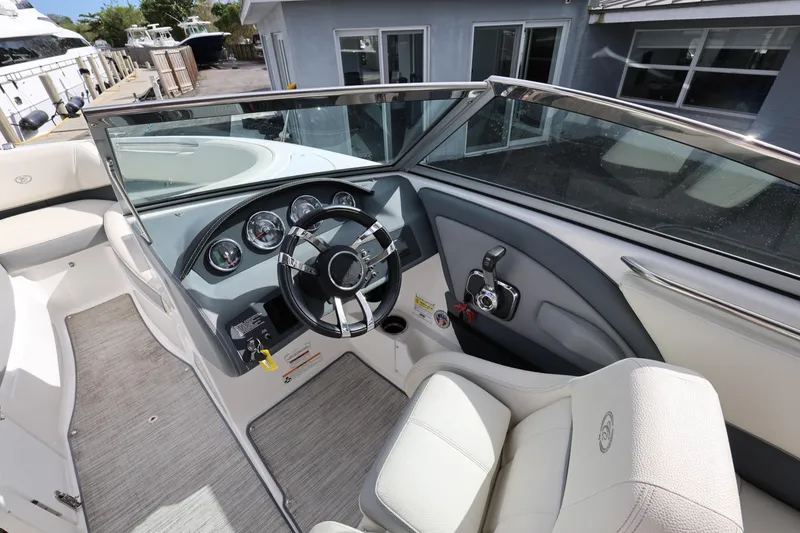 Slide: The Image of Interior view of 2022 Cobalt 220S boat cockpit with steering wheel and controls. - 12