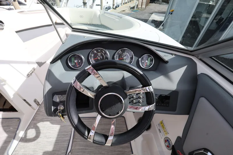 Slide: The Image of 2022 Cobalt 220S boat dashboard with steering wheel and gauges. - 13