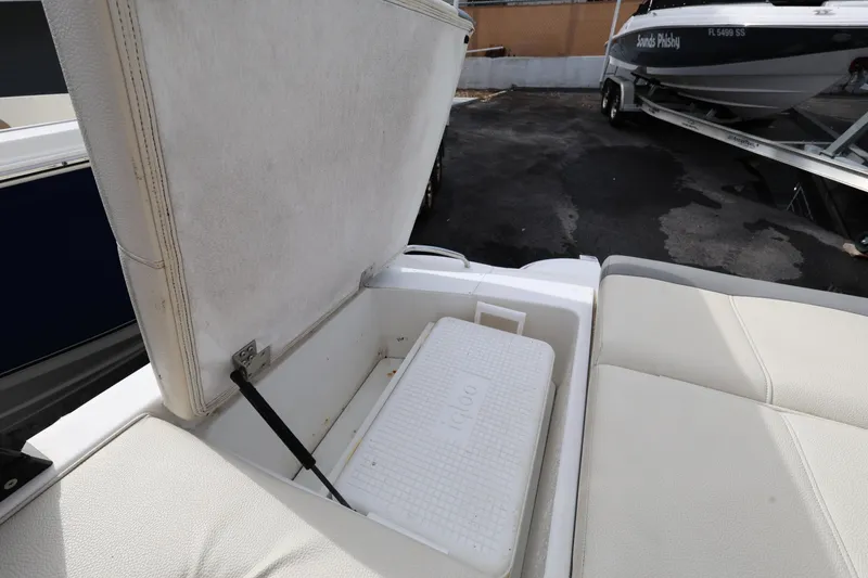 Slide: The Image of Open storage compartment on 2022 Cobalt 220S boat with Igloo cooler inside. - 24