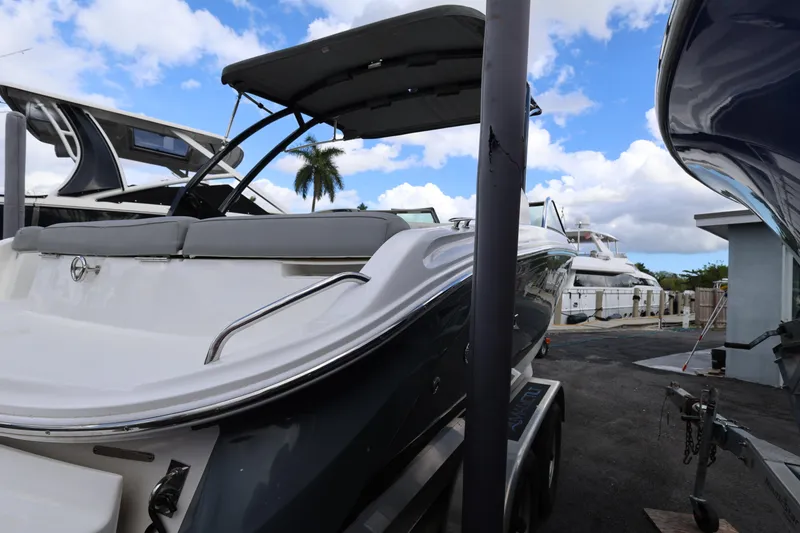 Slide: The Image of 2022 Cobalt 220S boat on trailer, docked with other yachts, under blue sky. - 9