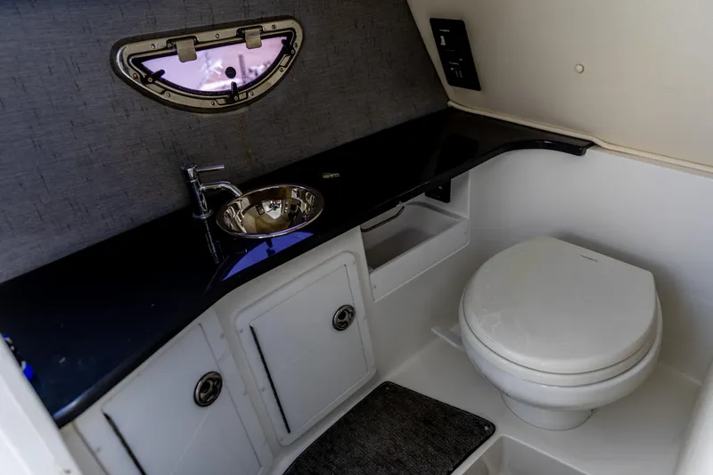 Slide: The Image of 2020 Cobalt 30SC Outboard boat interior with white seating and modern dashboard. - 2