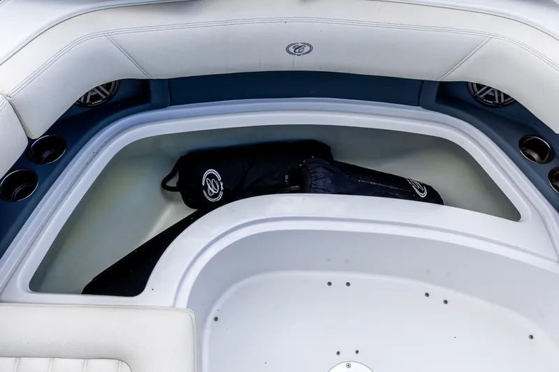 Slide: The Image of 2020 Cobalt 30SC Outboard boat interior with storage compartment and cup holders. - 24