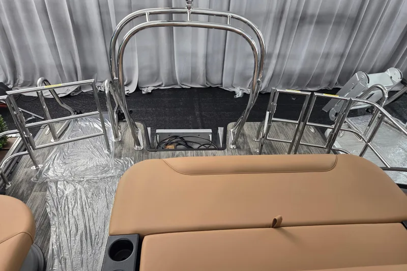 Slide: The Image of 2026 Godfrey SWEETWATER 2486 SFL boat interior with tan seating and stainless steel railings. - 6