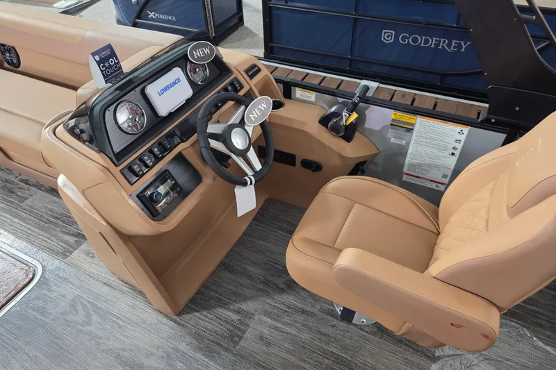 Slide: The Image of Interior of 2026 Godfrey SWEETWATER 2486 SFL boat with tan seating and modern dashboard. - 8