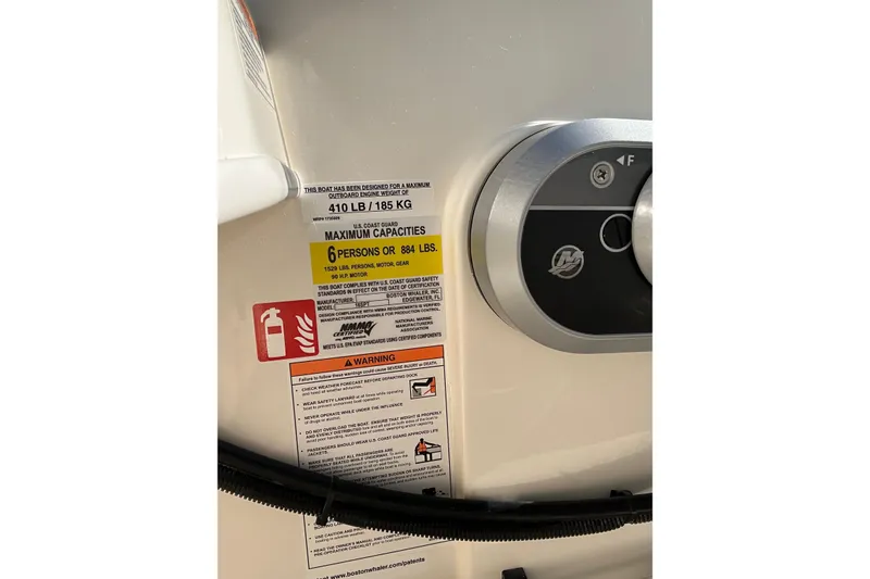 Slide: The Image of 2026 Boston Whaler 160 Super Sport capacity label, showing weight and passenger limits. - 12