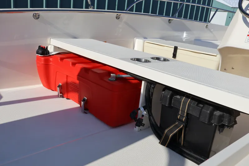 Slide: The Image of 2026 Boston Whaler 160 Super Sport interior with red fuel tank and storage compartments. - 14
