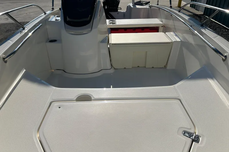 Slide: The Image of 2026 Boston Whaler 160 Super Sport boat interior with seating and storage. - 15