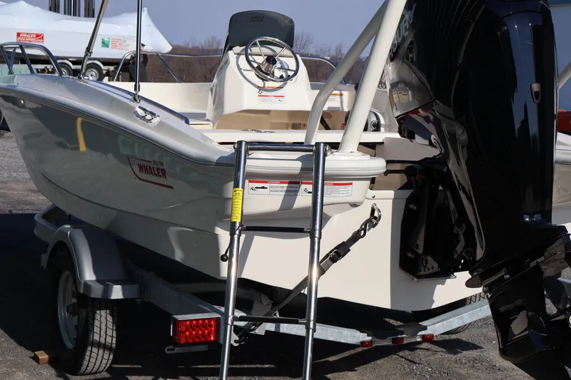 Slide: The Image of 2026 Boston Whaler 160 Super Sport boat on trailer, rear view with motor. - 5