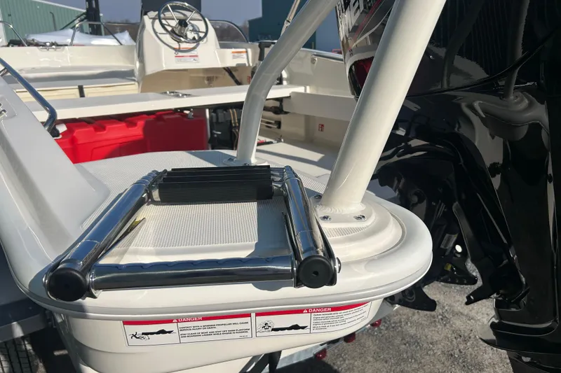 Slide: The Image of 2026 Boston Whaler 160 Super Sport boat ladder and deck detail in sunlight. - 6